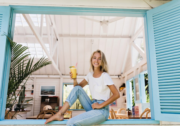 happy lady sitting in the window of her vacation rental